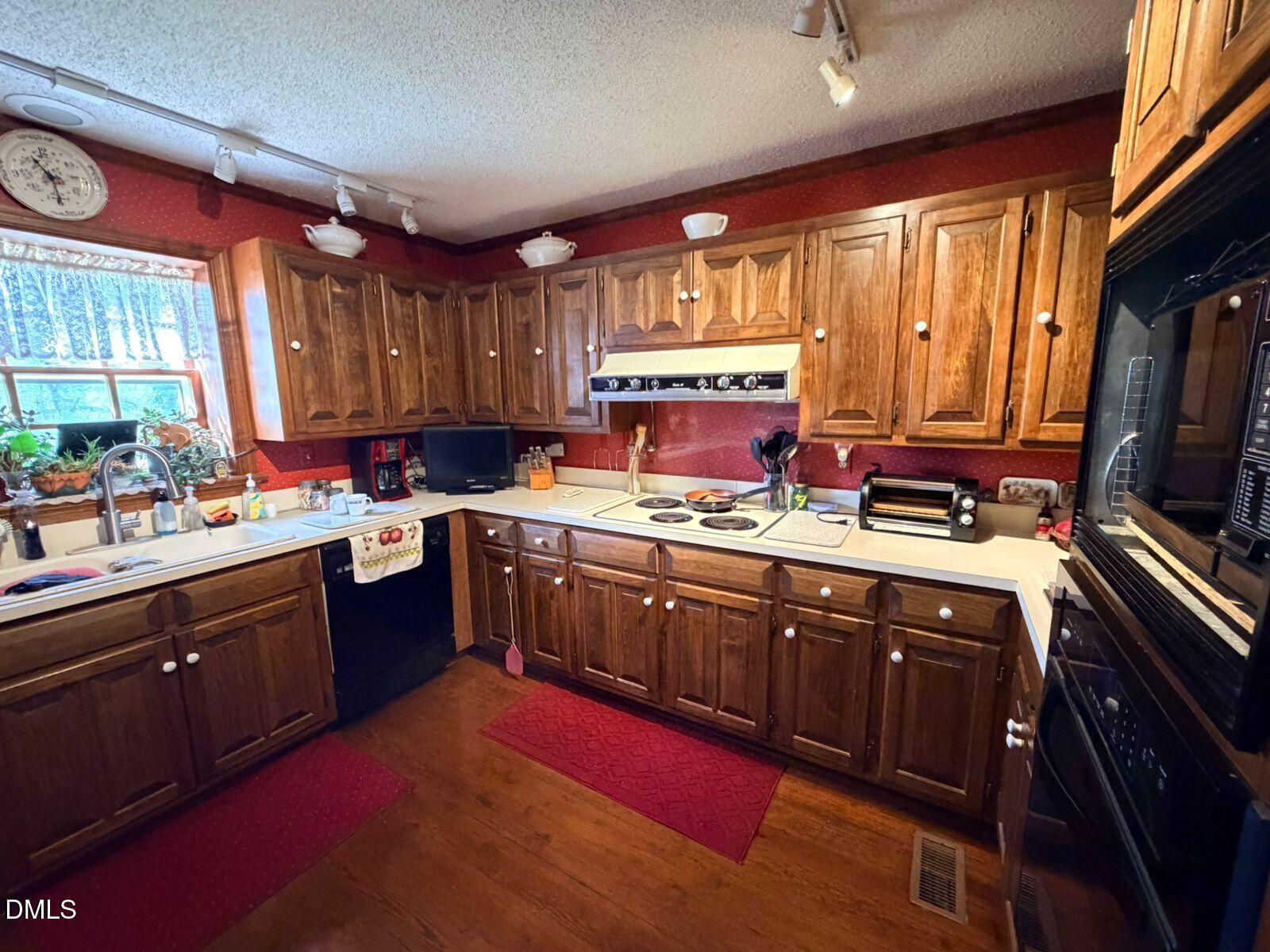9222 Midway Road Bailey, NC 27807 - Photo 9 of 35 a kitchen with stainless steel appliances sink cabinets and a large window