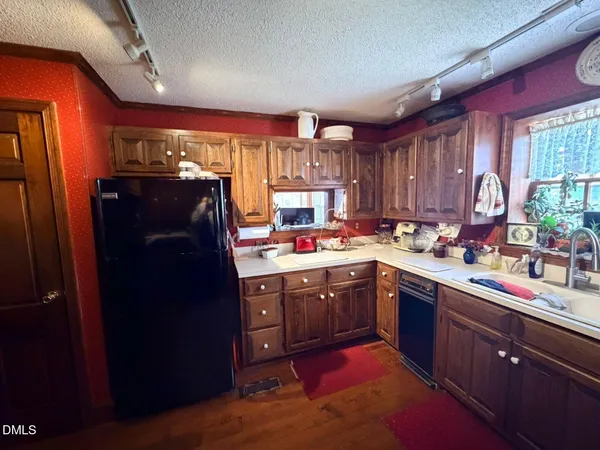 a kitchen with sink window and cabinets