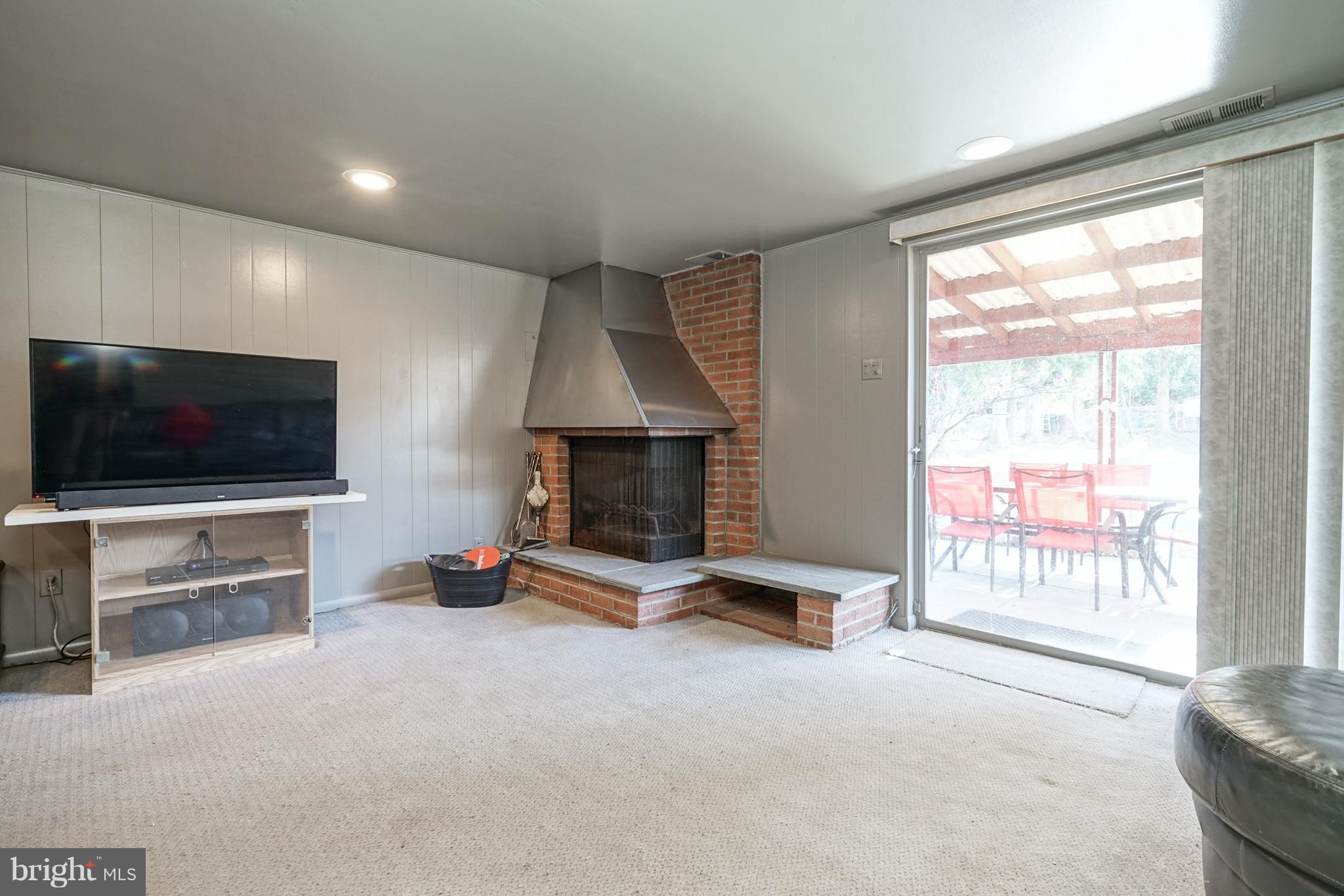 11011 Rennard Street Philadelphia, PA 19116 - Photo 23 of 29 Basement With Fireplace & Sliders To Covered Patio