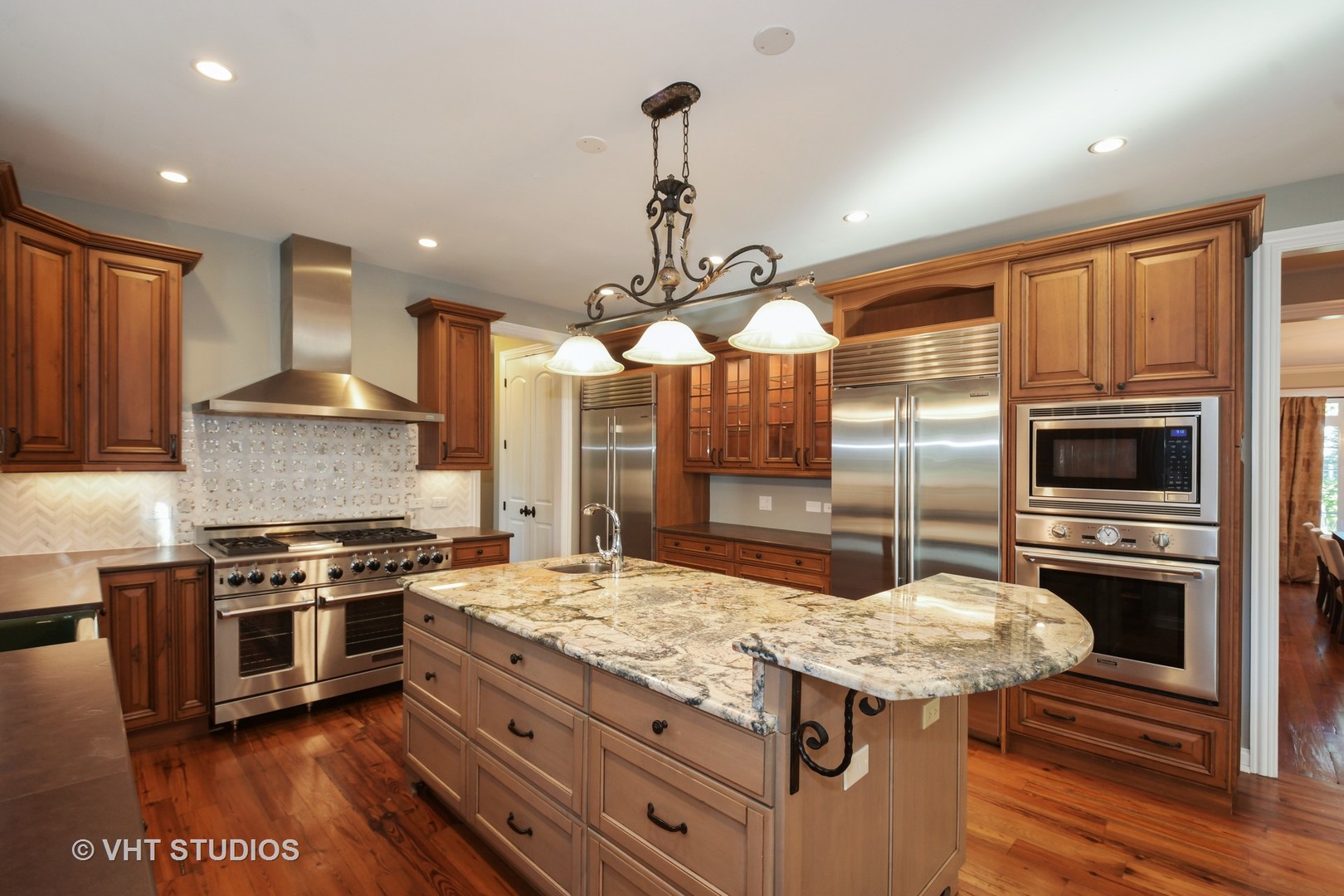 1021 Linden Lane Glenview, IL 60025 - Photo 4 of 26 a kitchen with kitchen island granite countertop wooden cabinets and stainless steel appliances
