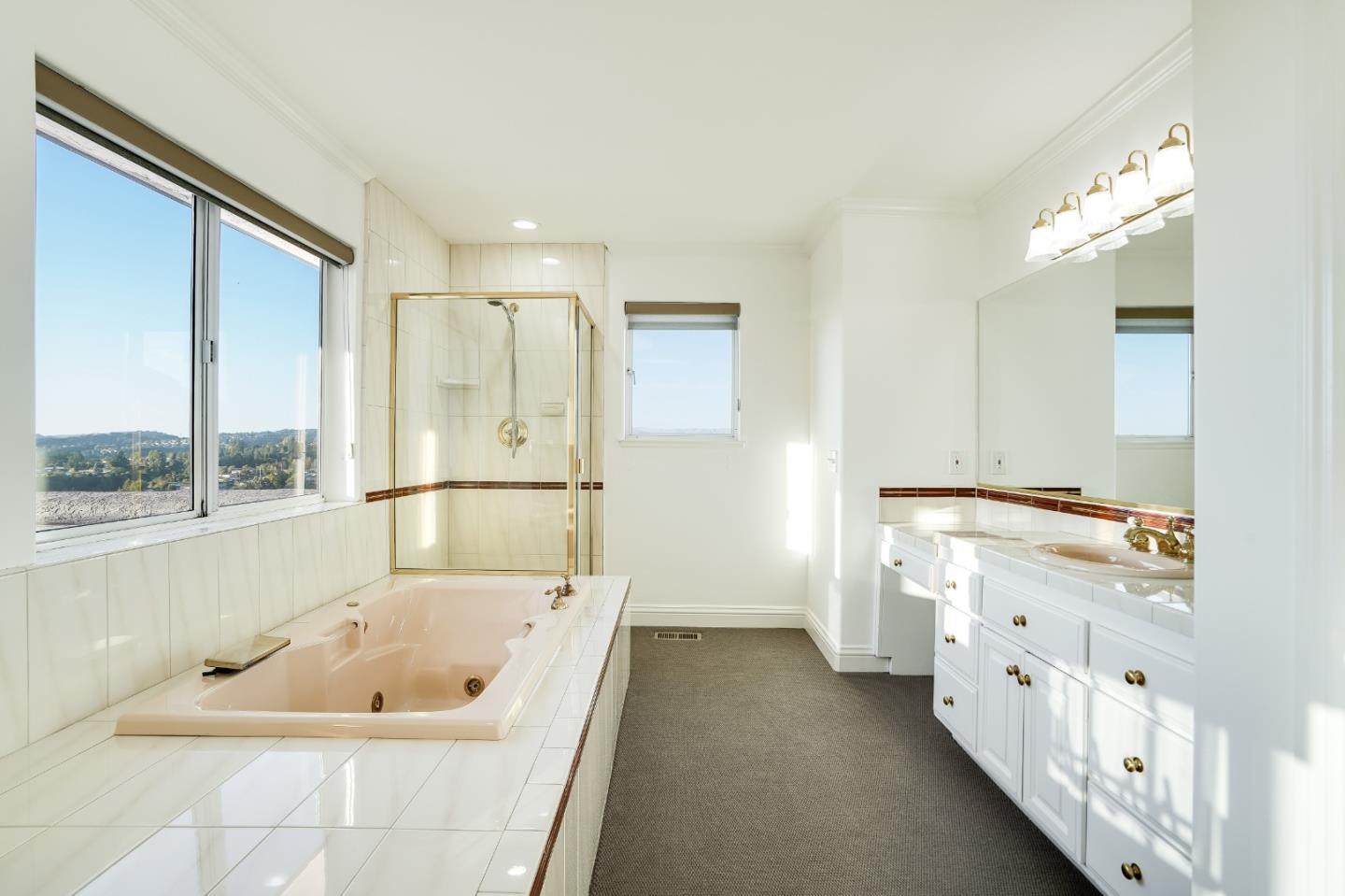 20460 Viewpoint Road Castro Valley, CA 94552 - Photo 30 of 50 a bathroom with a tub a double vanity sink and mirror