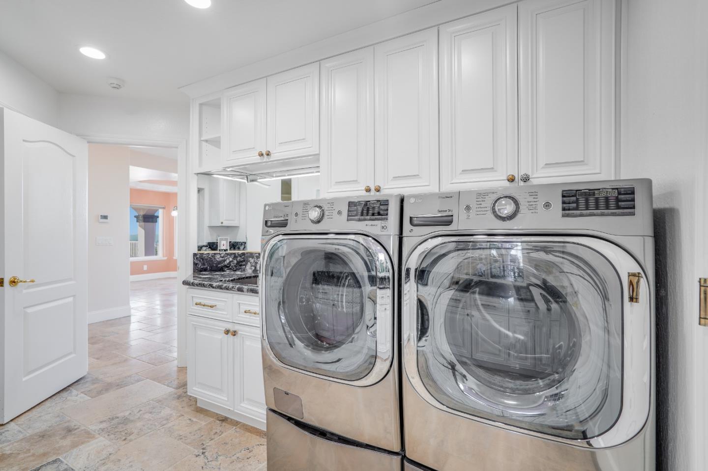 20460 Viewpoint Road Castro Valley, CA 94552 - Photo 35 of 50 a kitchen with white cabinets and washer dryer