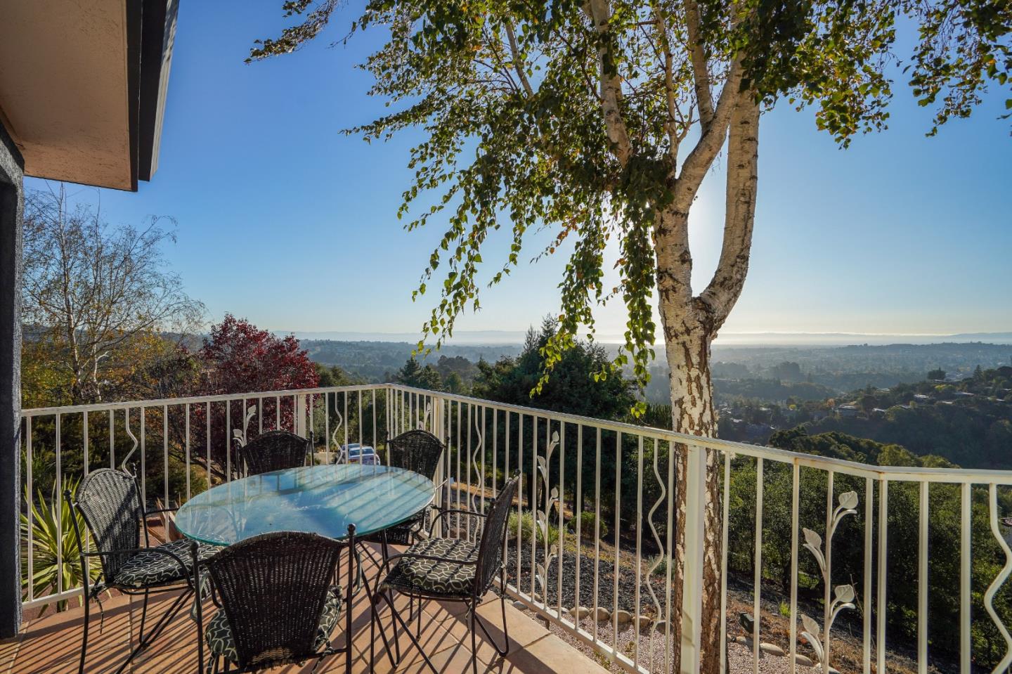 20460 Viewpoint Road Castro Valley, CA 94552 - Photo 43 of 50 a view of a balcony with table and chairs and wooden floor