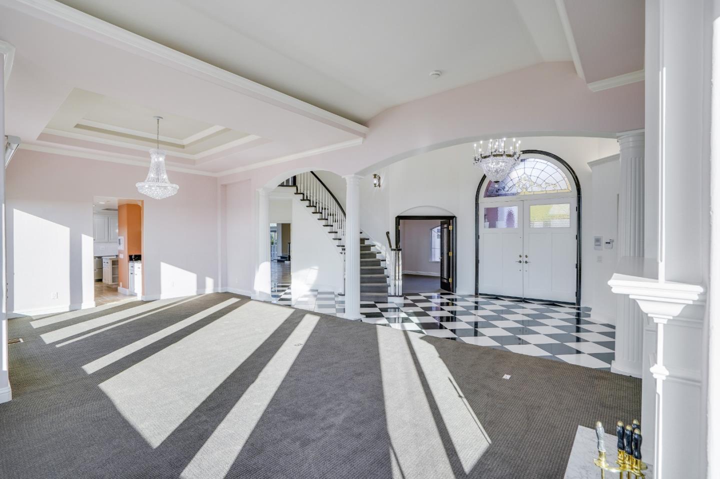 20460 Viewpoint Road Castro Valley, CA 94552 - Photo 9 of 50 a spacious bedroom with a bed a mirror and chandelier