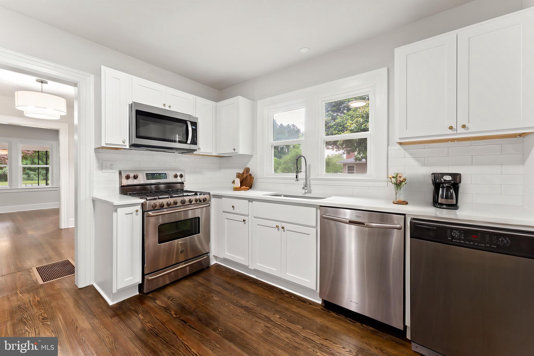 10221 Dahlgren Road King George, VA 22485 - Photo 6 of 31 a kitchen with cabinets stainless steel appliances and wooden floor