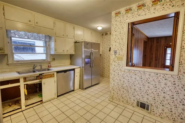 a kitchen with a sink stove and cabinets