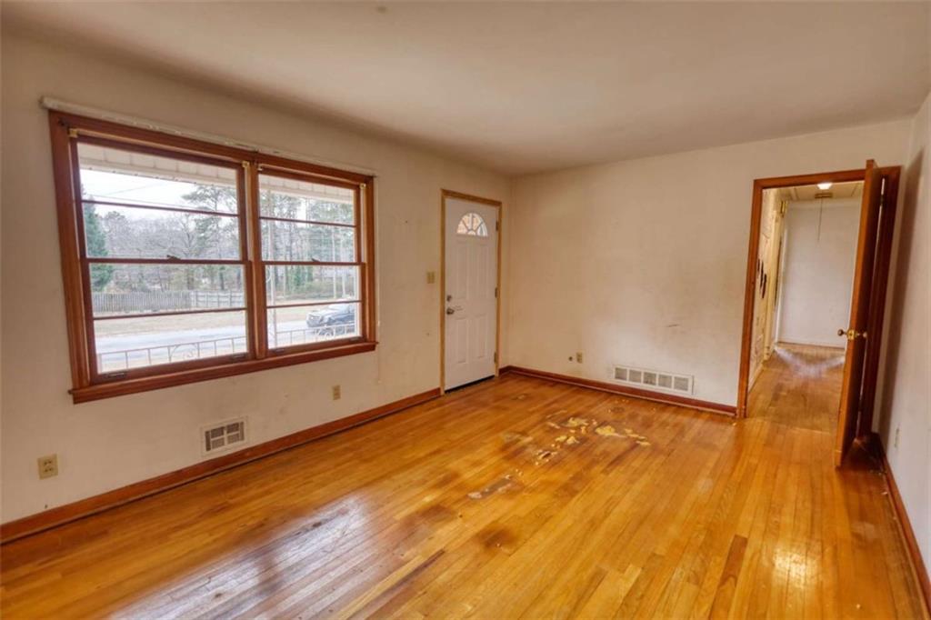 1924 Mural Circle Morrow, GA 30260 - Photo 9 of 41 a view of an empty room with wooden floor and a window