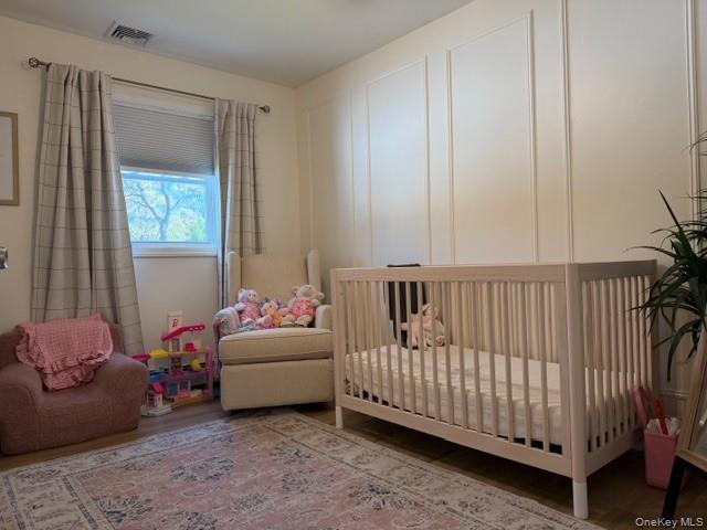 10 Hollingsworth Place Centereach, NY 11720 - Photo 14 of 19 a bedroom with furniture and a window