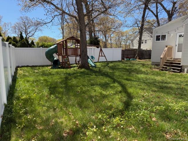 10 Hollingsworth Place Centereach, NY 11720 - Photo 19 of 19 a view of a backyard with wooden fence
