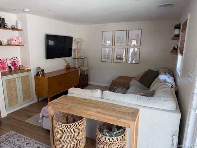 10 Hollingsworth Place Centereach, NY 11720 - Photo 5 of 19 a bedroom with a bed and flat screen tv