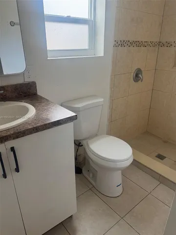 a bathroom with a toilet sink and shower