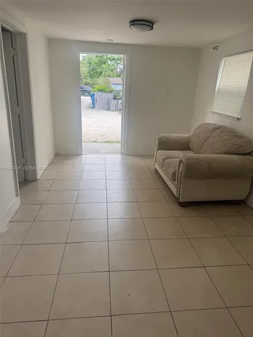 a living room with a couch and a window
