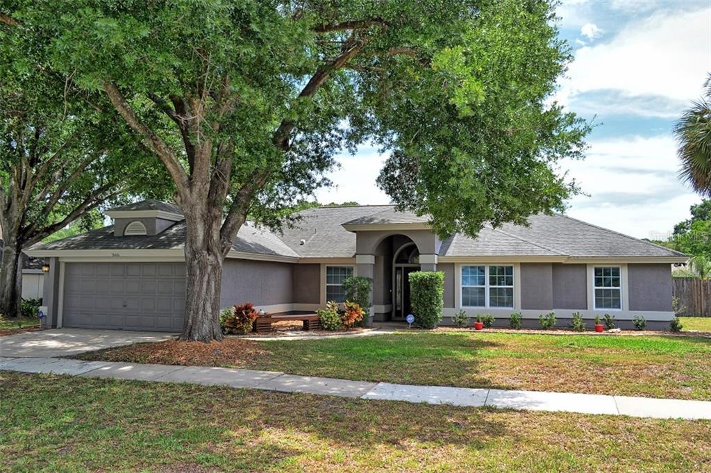 365 Crystal Ridge Way Lake Mary, FL 32746 - Photo 1 of 1 a front view of a house with a yard table and chairs