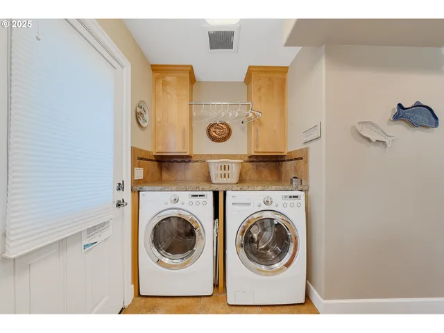 a bedroom with a large bed a chandelier and a window