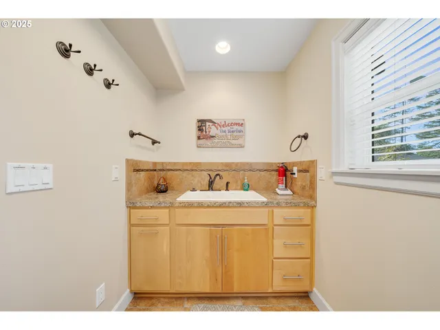 a bathroom with a sink vanity granite tub and a mirror