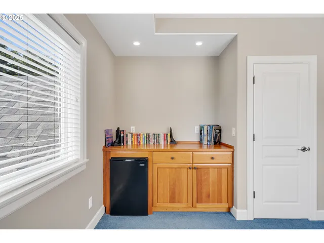 a view of a refrigerator in an empty room