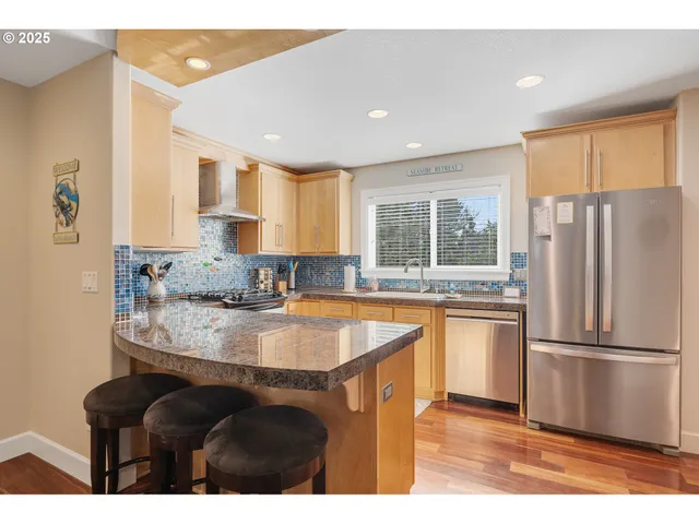 a kitchen with a sink a stove and a microwave