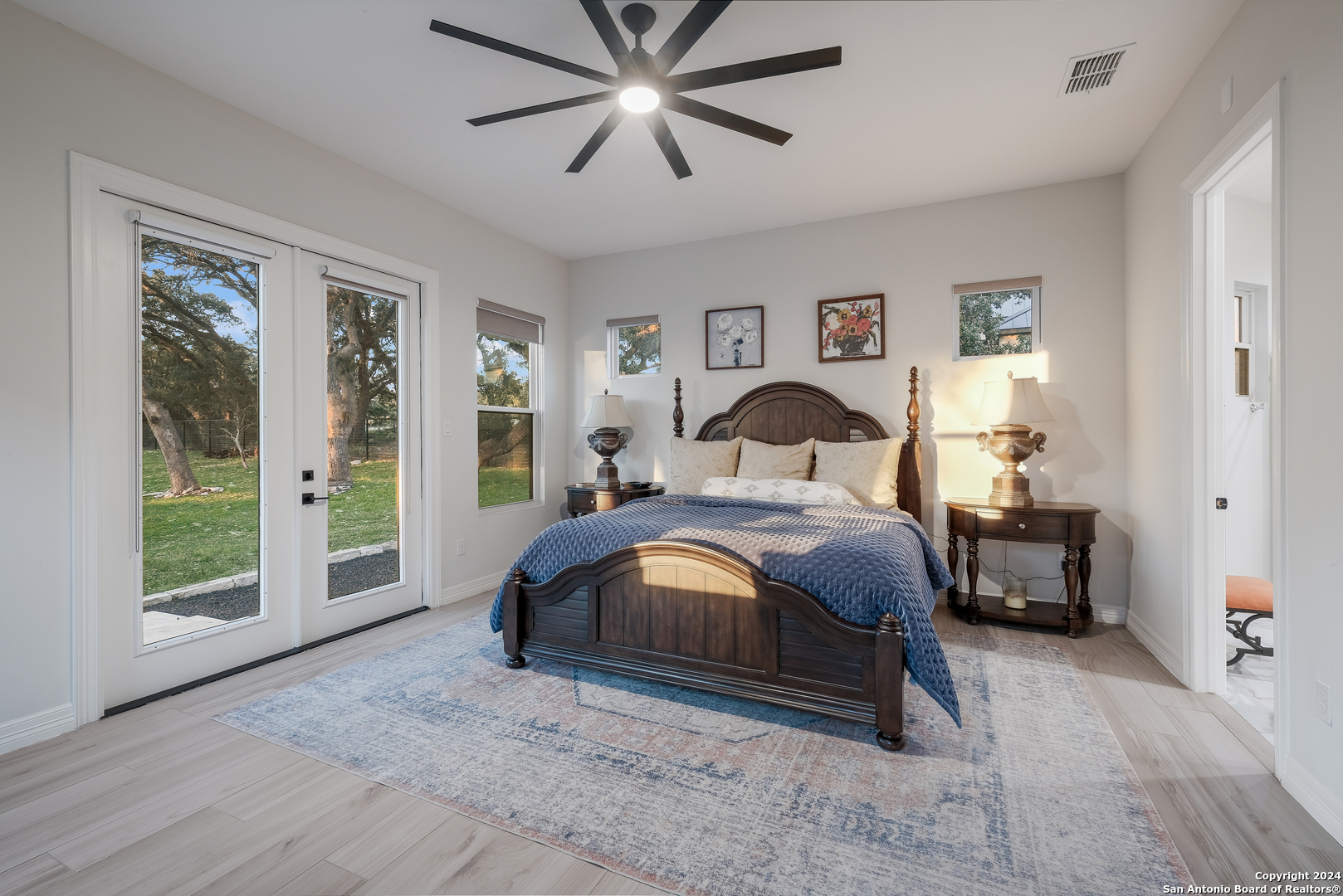718 Post Oak Ridge Way Bulverde, TX 78163 - Photo 14 of 60 a spacious bedroom with a large bed and a window