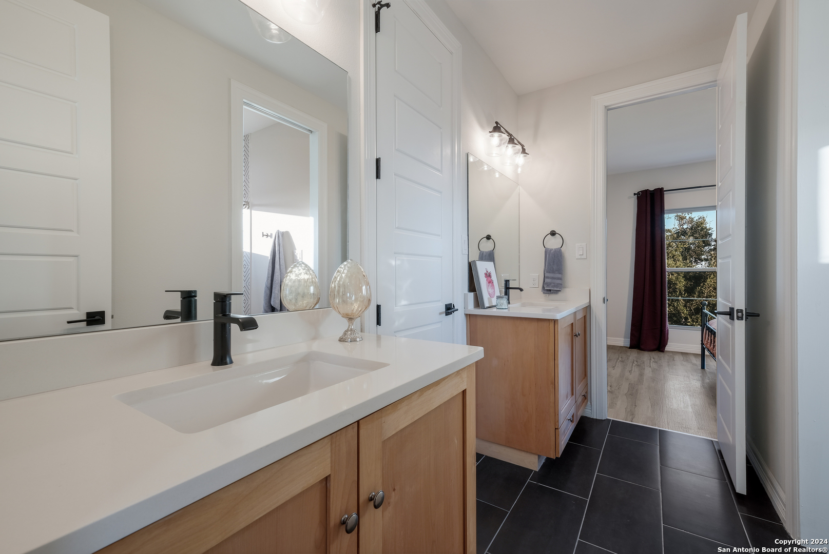 718 Post Oak Ridge Way Bulverde, TX 78163 - Photo 25 of 60 a bathroom with a sink and a mirror
