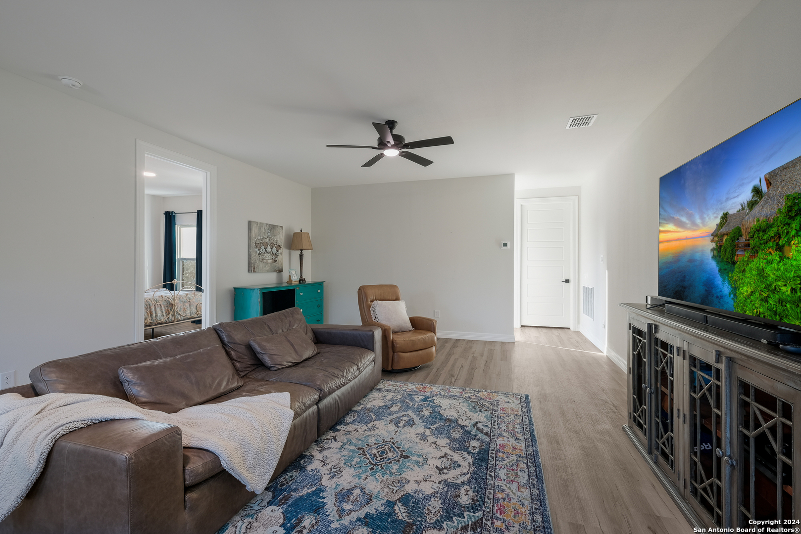 718 Post Oak Ridge Way Bulverde, TX 78163 - Photo 28 of 60 a living room with furniture and a flat screen tv