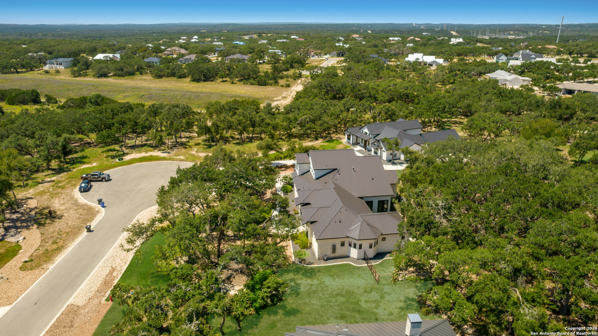 718 Post Oak Ridge Way Bulverde, TX 78163 - Photo 42 of 60 an aerial view of residential houses with outdoor space and trees