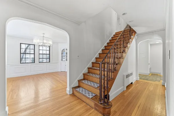 a view of entryway and hall with wooden floor