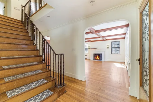 a view of a hallway with wooden floor and staircase