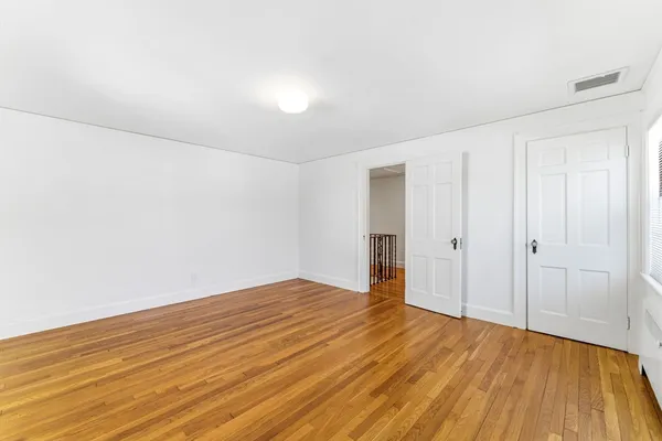 a view of a room with wooden floor and fence