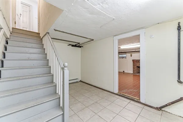 a view of empty room with wooden floor and fireplace