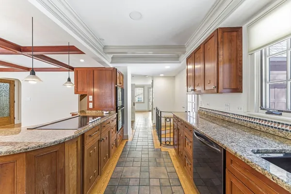 a kitchen with stainless steel appliances granite countertop a sink and wooden cabinets