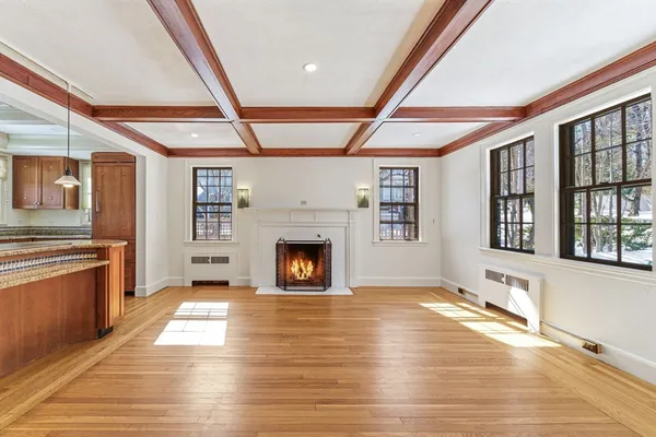 a view of an empty room with a fireplace and a window