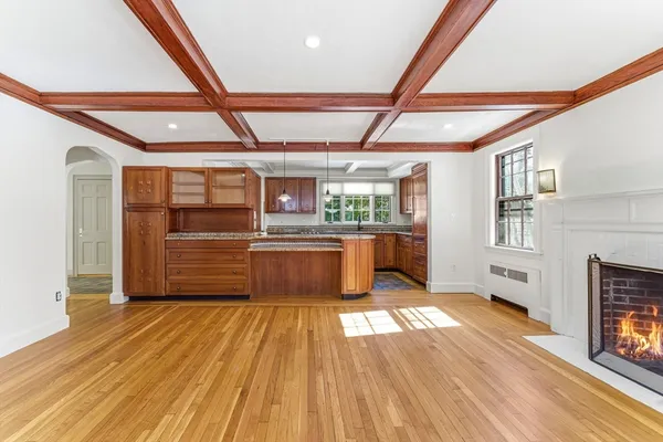 a kitchen with stainless steel appliances wooden floor and a refrigerator