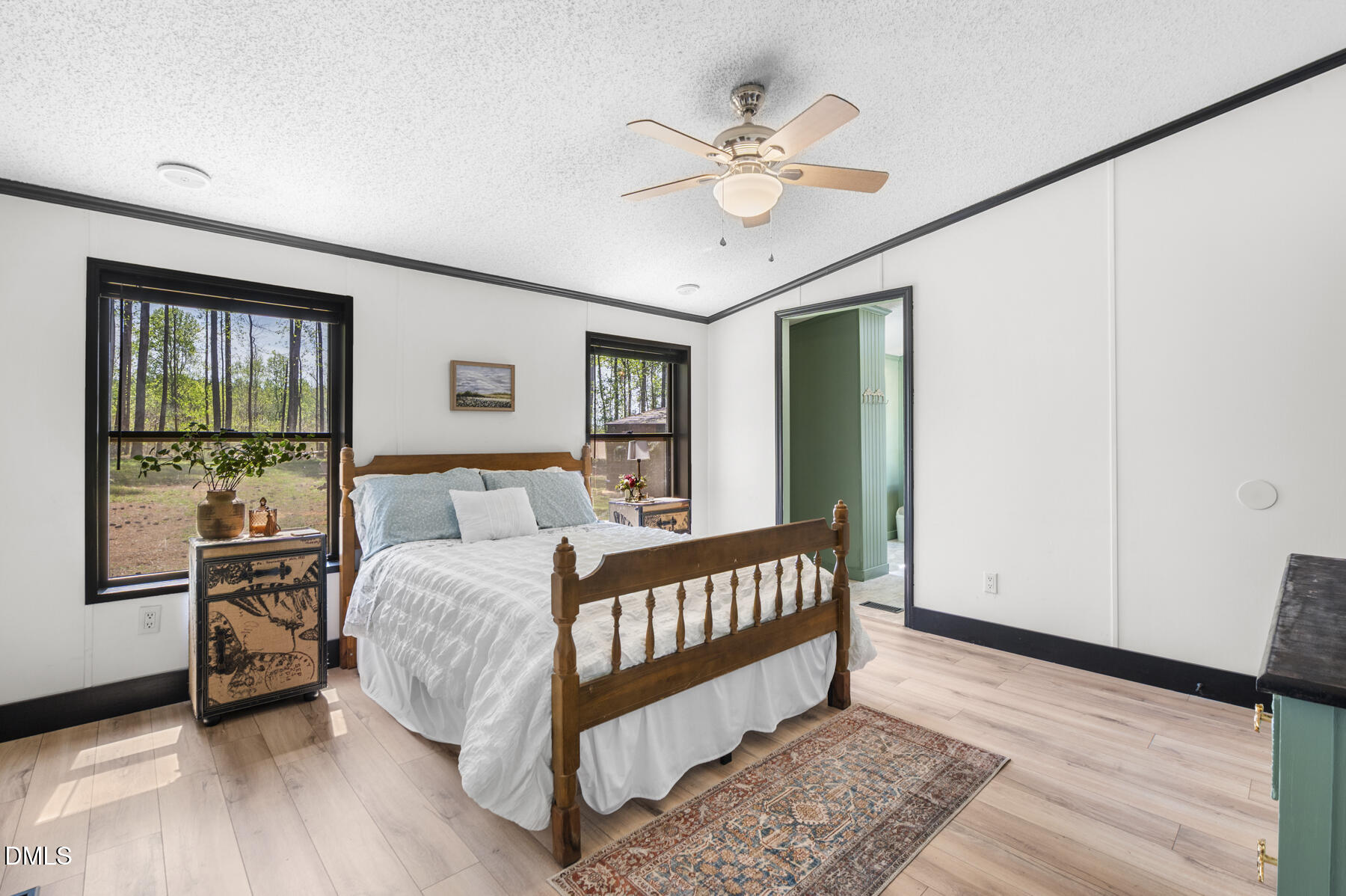 492 Little Mill Road Henderson, NC 27537 - Photo 20 of 39 a bedroom with a bed lamp and a large window with wooden floor