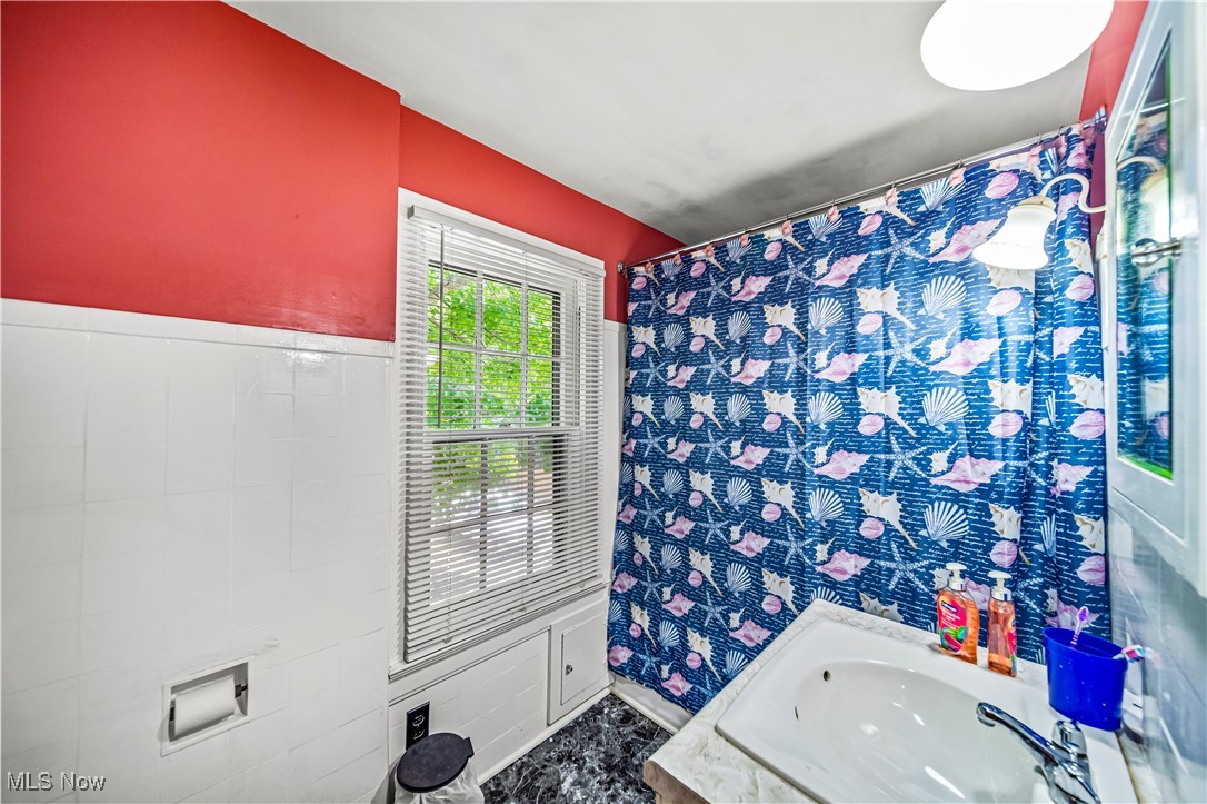 8219 Midland Road Mentor, OH 44060 - Photo 24 of 34 Bathroom featuring sink and tile walls