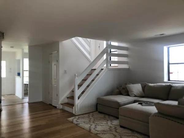 a living room with furniture and stairs