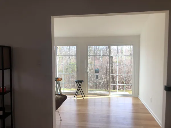 a view of a room with wooden floor
