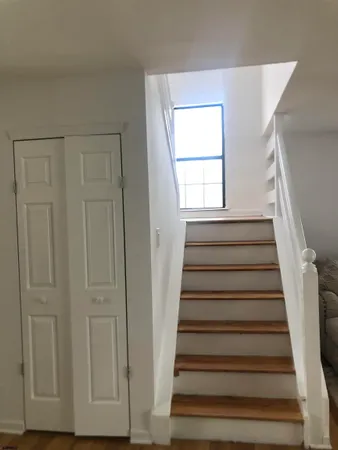 a kitchen with stainless steel appliances granite countertop a stove a sink and white cabinets