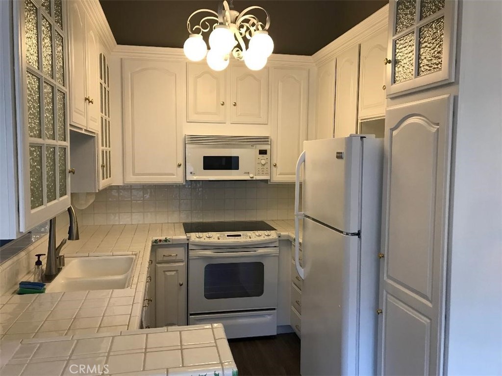 5945 Armaga Spring Road, Unit B Rancho Palos Verdes, CA 90275 - Photo 3 of 11 a kitchen with a stove a refrigerator and cabinets