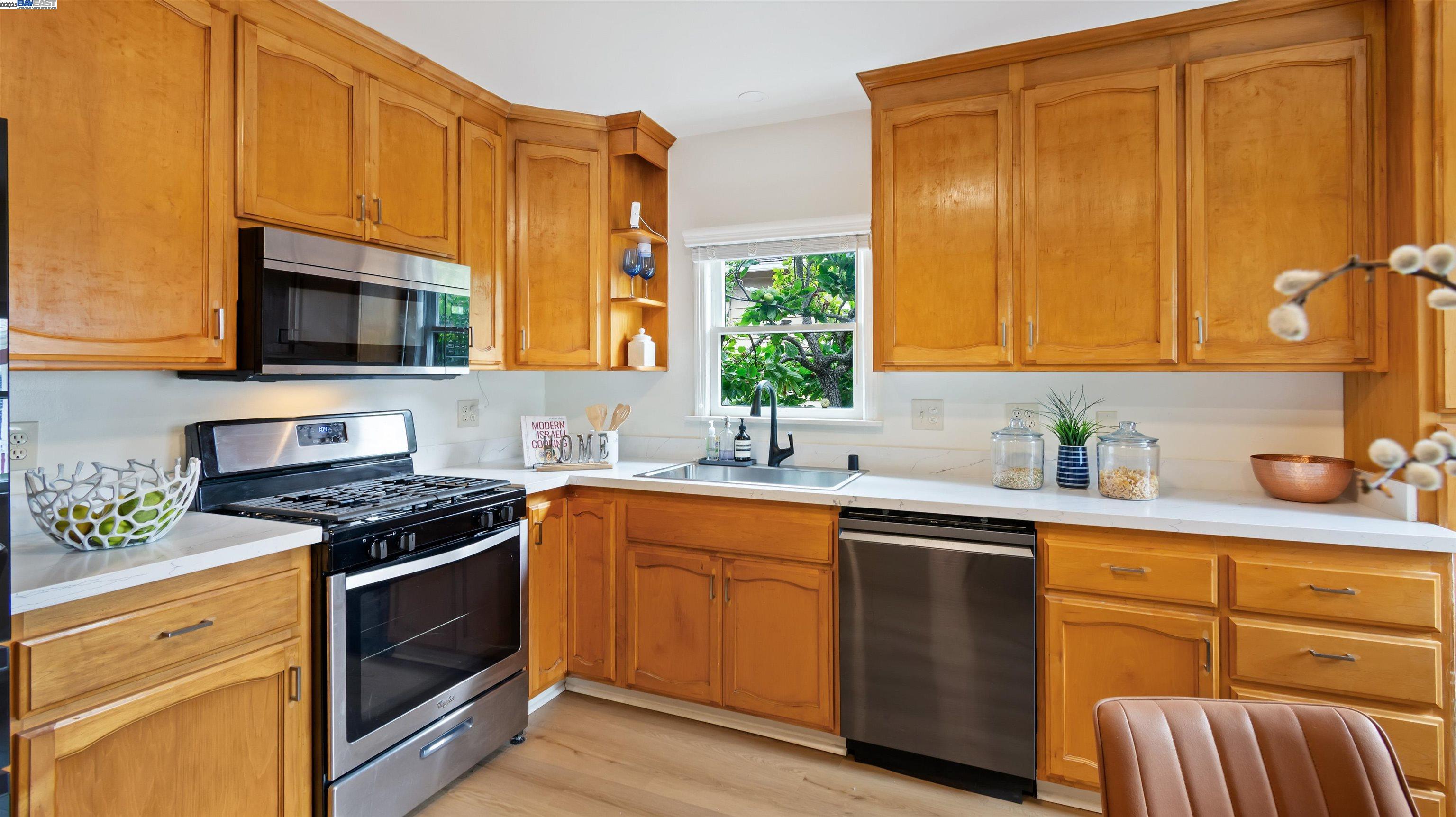 830 Buena Vista Avenue Alameda, CA 94501 - Photo 13 of 28 a kitchen with stainless steel appliances granite countertop wooden cabinets stove top oven and sink