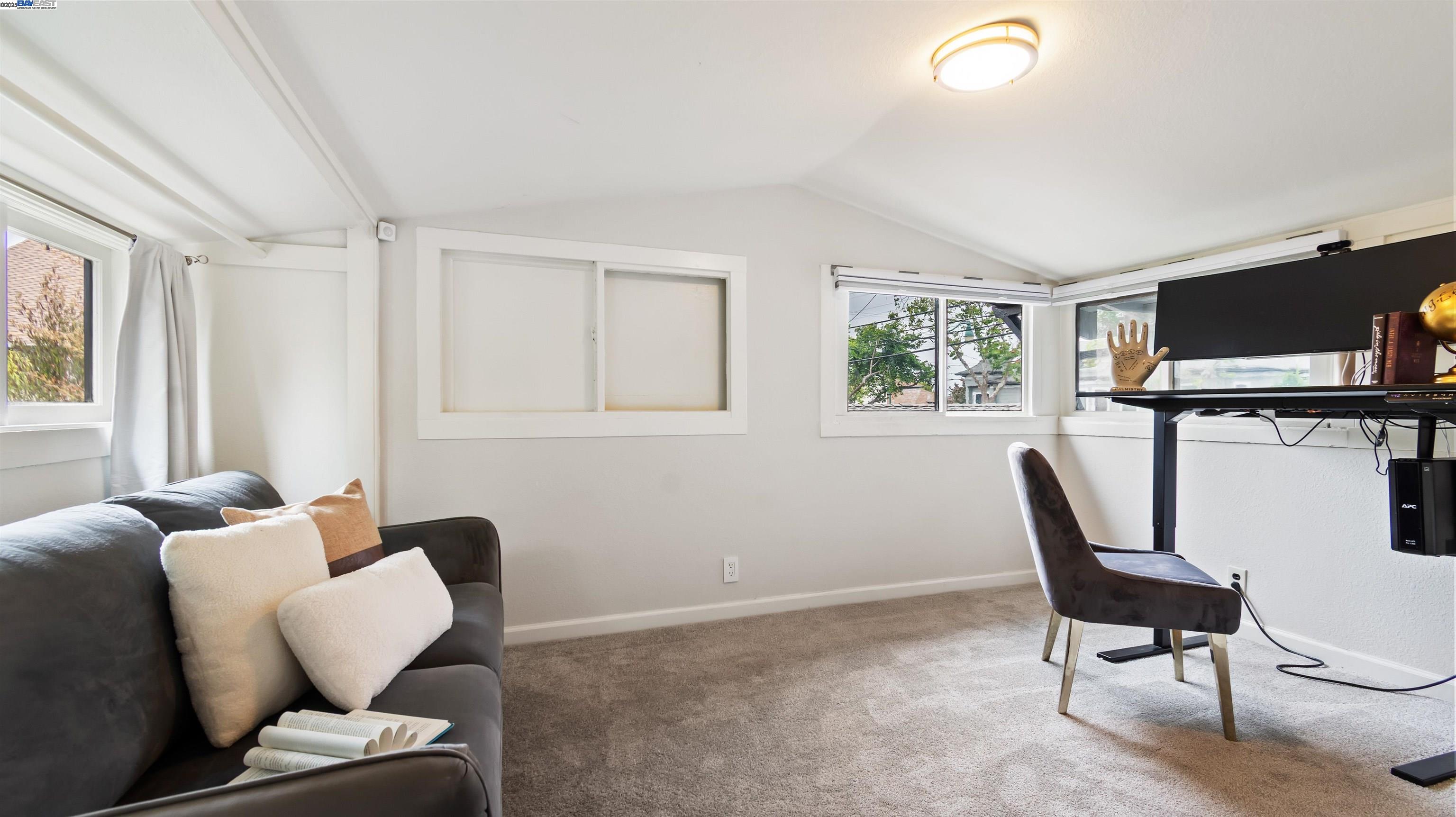 830 Buena Vista Avenue Alameda, CA 94501 - Photo 19 of 28 a living room with furniture a flat screen tv and a window
