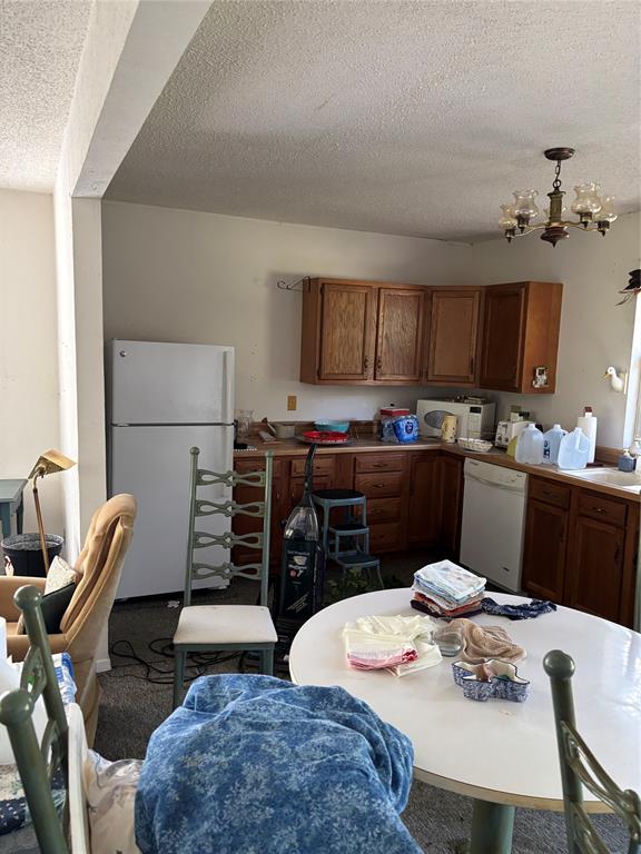 10236 County Road 2326, Unit TRACT 1 Terrell, TX 75160 - Photo 15 of 19 a kitchen with stainless steel appliances kitchen island granite countertop a dining table and chairs