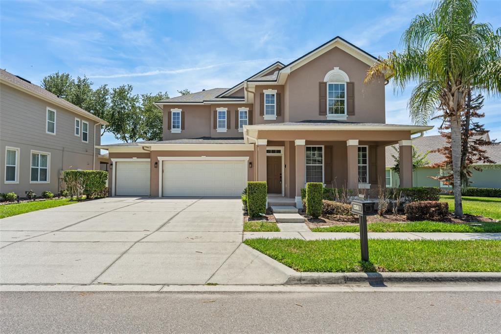 a front view of a house with a yard and garage
