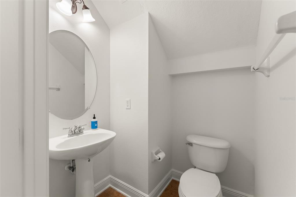 13544 Riggs Way Windermere, FL 34786 - Photo 14 of 58 a bathroom with a sink mirror toilet and vanity