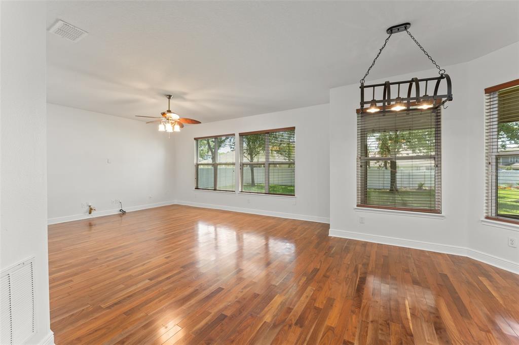 13544 Riggs Way Windermere, FL 34786 - Photo 16 of 58 a view of an empty room with wooden floor and a window