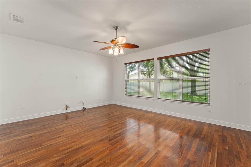 13544 Riggs Way Windermere, FL 34786 - Photo 19 of 58 an empty room with wooden floor and windows