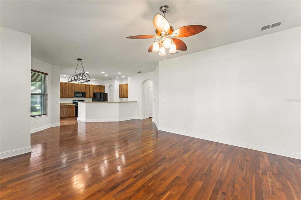 13544 Riggs Way Windermere, FL 34786 - Photo 21 of 58 a view of a kitchen with wooden floor and a chandelier