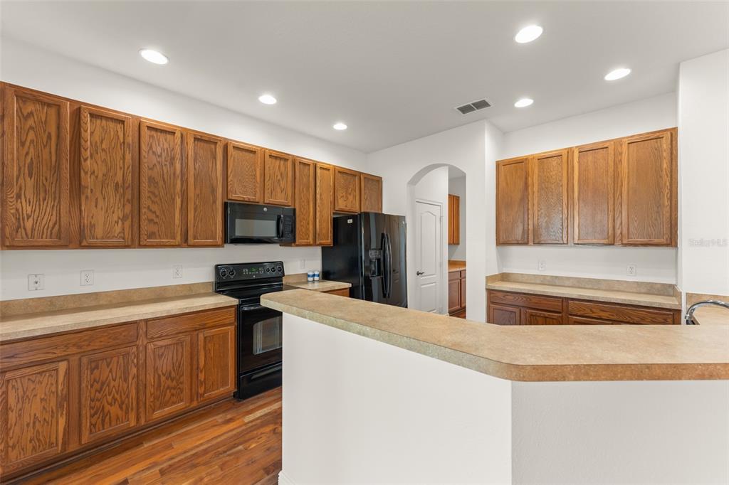 13544 Riggs Way Windermere, FL 34786 - Photo 23 of 58 a kitchen with stainless steel appliances granite countertop a refrigerator sink and cabinets