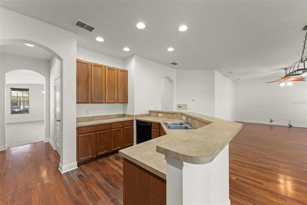 13544 Riggs Way Windermere, FL 34786 - Photo 25 of 58 a kitchen with a stove a sink and a refrigerator