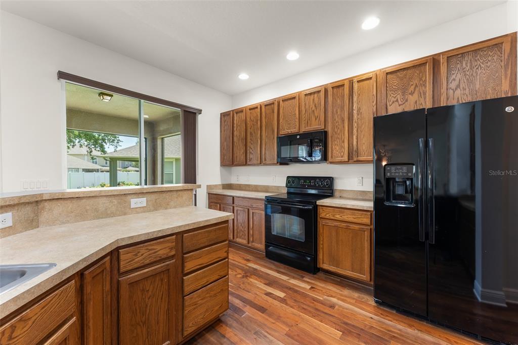 13544 Riggs Way Windermere, FL 34786 - Photo 27 of 58 a kitchen with a sink stove and refrigerator