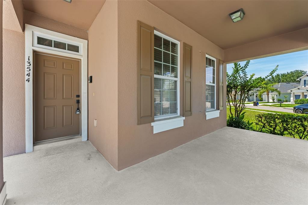 13544 Riggs Way Windermere, FL 34786 - Photo 3 of 58 a view of a house with a garden